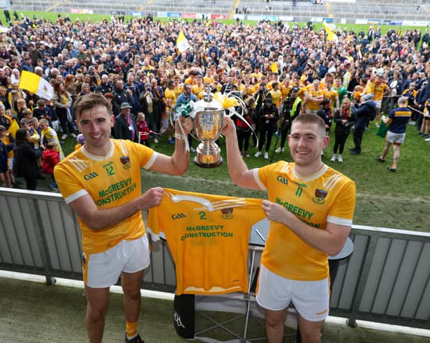 Charlie Carr and Stephen McConville lift the Frank O'Hare Cup after beating Burren in the Down Senior Championship Final on Sunday.