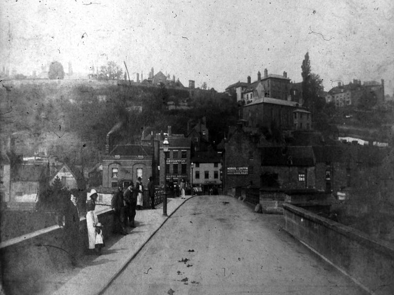 The information with this photo looking over Bridgnorth Bridge says: "Before Cliff Railway was made. The first figure on the left is John Taylor, property owner and a weaver known as gentleman John . In that day he was the only one to work in cloth clothes."