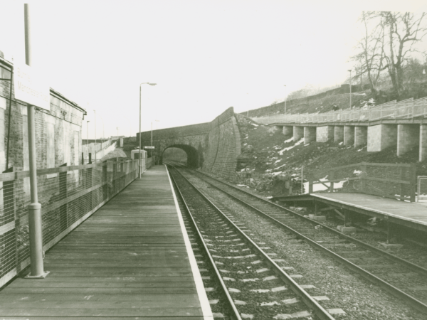 A photograph of Manchester Road Railway Station taken shortly after it re-opened to the public in October 1986 on the Leeds-Preston Line. The picture was taken looking down the platform towards the tunnel under Manchester Road where the train emerges on it's journey to Preston.