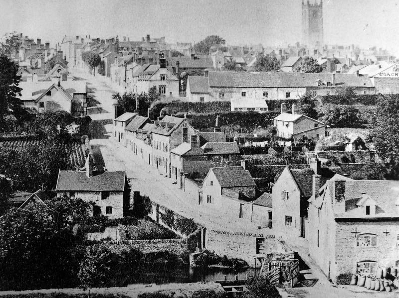 Lower Mill Street, Ludlow, with the town's cathedral-like parish church top right. The picture came from Angela Siminson, of Lower Mill Street, but used to belong to a neighbour, Robert Dinsmore, who died in 2013. The building about half way up with the bell or clock tower on the right hand side of the street is the old Ludlow Grammar School. Ludlow mill is bottom right with sacks outside.