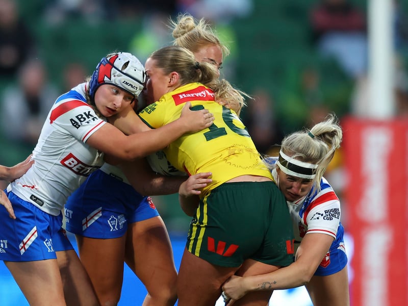 Wigan halfback Izzy Rowe helps tackle Australia's Makenzie Weale
