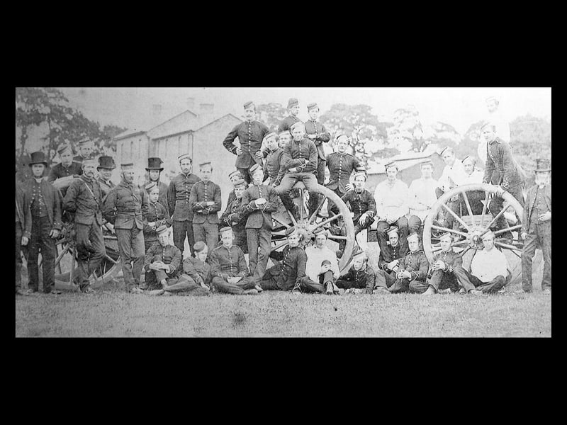 1st Shropshire Artillery Volunteers, Shrewsbury, in 1860. It is an informal group of officers in patrol jackets, NCOs and gunners in stable dress and white fatigue jackets, with a sprinkling of policemen wearing top hats.