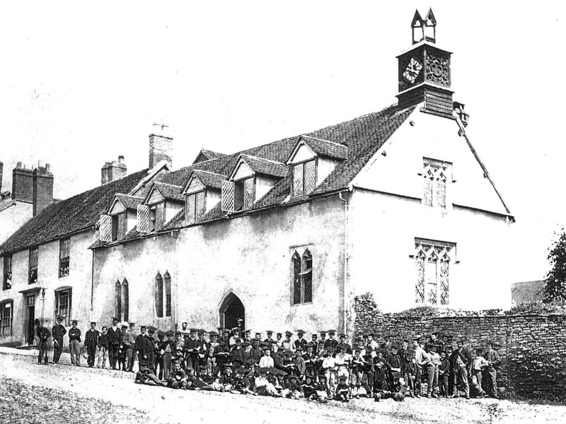Here's a closer view of the old grammar school, with the pupils posing outside. The building is the ancient Palmers Hall, which is still there of course, but the clock tower is not. These days it's at the other end of the building (or a replacement is). Why did it move? If we knew, we'd tell you.