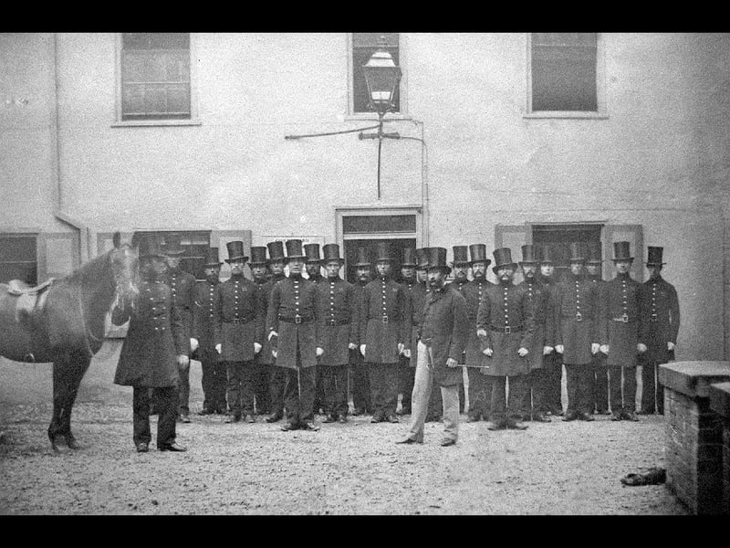 "Shropshire County Constabulary in 1859. Captain Crampton, Chief Constable, 1859 to 1864." It would be reasonable to assume Crampton is the chap in the foreground. The exact location of the picture is uncertain but may be the old county police headquarters in Swan Hill, Shrewsbury. This picture was saved when the police moved out of the headquarters to move to Monkmoor.