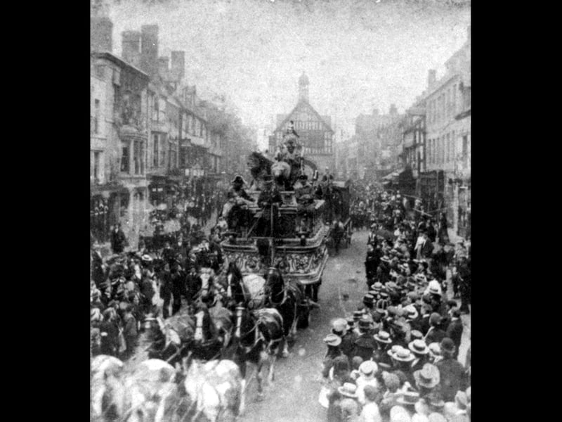 That's a parade and a half in Bridgnorth High Street. It could be a circus, but that's just a guess. Whatever it is, it's drawing a big crowd. And look closely, and you'll see that there's a lion on the horse-drawn wagon. Surely it can't be a real one? Bridgnorth Town Hall is the background.