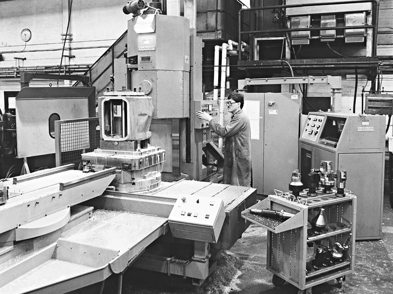 Gleaming control panels, cutting swarf, and massive automated milling equipment, this July 1982 photograph captures a machinist operating newly installed plant at the Turner Spicer works in Fordhouses. Spurred by rising demand for their ten speed truck gearboxes, the company invested two hundred thousand pounds into advanced British machinery to manufacture aluminium gearbox casings directly on site rather than importing them from America. The upgrade helped shorten supply routes, safeguard skilled regional work, and streamline specialised transmission orders, demonstrating the modern technological drive powering Wolverhampton engineering during the eighties. Do you remember working on the shop floor or tooling benches at the Turner Spicer plant in Fordhouses? Who recalls the major industrial investment and machinery upgrades arriving across local factories in the summer of 1982?