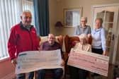 Cecil Darragh and his late wife, Emily, pictured presenting the proceeds from their recent 60th wedding anniversary and Mr Darragh's 90th birthday to representatives of Air Ambulance NI and Cancer Research UK.