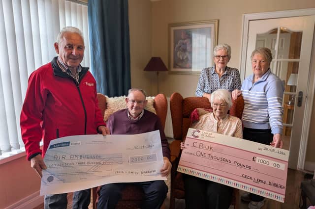Cecil Darragh and his late wife, Emily, pictured presenting the proceeds from their recent 60th wedding anniversary and Mr Darragh's 90th birthday to representatives of Air Ambulance NI and Cancer Research UK.