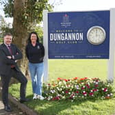 Past captains, Blaine Nugent and Vicki McCausland beside the new 'welcomes' sign they have sponsored.