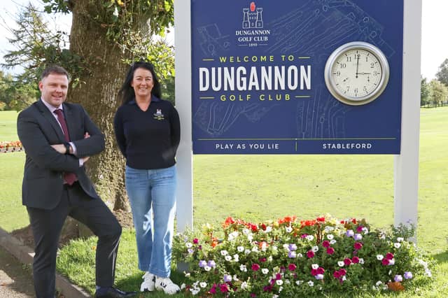 Past captains, Blaine Nugent and Vicki McCausland beside the new 'welcomes' sign they have sponsored.