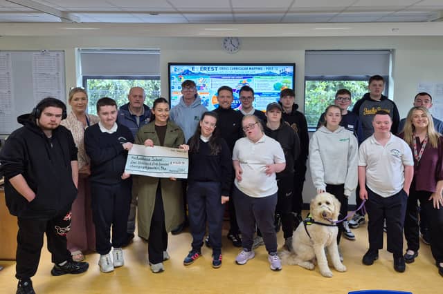 The Breslin family pictured presenting the proceeds of the 'Jog For Joe' to staff and pupils of Knockavoe School.