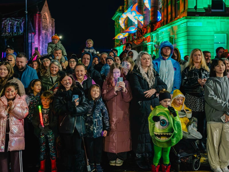 Halloween fans enjoy watching the parade.