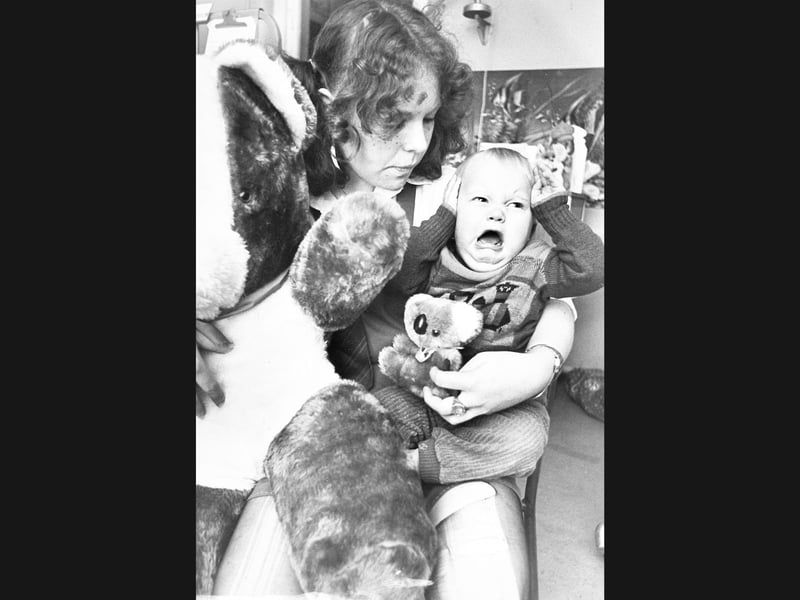 Little Stuart Dandy covers his ears and lets out a wail during his first birthday celebrations in the children's ward at New Cross Hospital, Wolverhampton, in December 1982. Faced with a choice between two teddy bears brought in as Christmas presents, the tearful one-year-old was comforted by 19-year-old Wendy Cunningham. Wendy, dressed in a St Trinian’s costume, helped hand out toys alongside £135 collected by generous regulars from the Spread Eagle pub in Willenhall to bring festive cheer to young patients. Do you remember the fundraising visits made to New Cross Hospital by local pub regulars back in the winter of 1982?