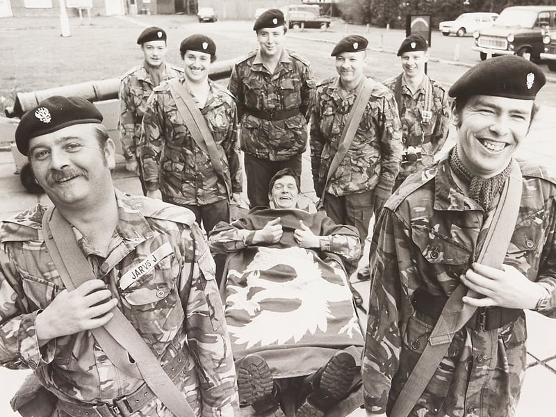 Lance Corporal Bernie McGloin gives a thumbs up from a stretcher as his Territorial Army colleagues prepare to carry him on an ambitious 20-mile charity trek from their Fallings Park headquarters in April 1982. The soldiers of HQ Company, 1st Battalion Mercian Volunteers, including front bearers Corporal John Jarvis and Private Mac Speed, backed by Stephen Thomas, Eddie Hyde, Ivor Wilcox, Neil Alexander, and John Benton, walked all the way to Cannock and back to buy a kidney dialysis machine for the children's ward at the Royal Hospital, Wolverhampton. Do you recall cheering on the Mercian Volunteers during their 20-mile stretcher haul back in the spring of 1982?