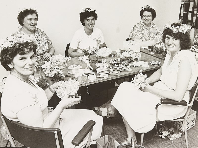 Ladies in a floristry class proudly wear handcrafted bridesmaids' garlands around a table laden with ribbons and blooms at Compton Grange Adult Education Centre, Compton Road West, Wolverhampton, in August 1982. The centre provided a vibrant space for local residents to learn practical crafts, share creative hobbies, and build community friendships throughout the year. Did you ever attend floristry classes or other courses at Compton Grange back in the 1980s?