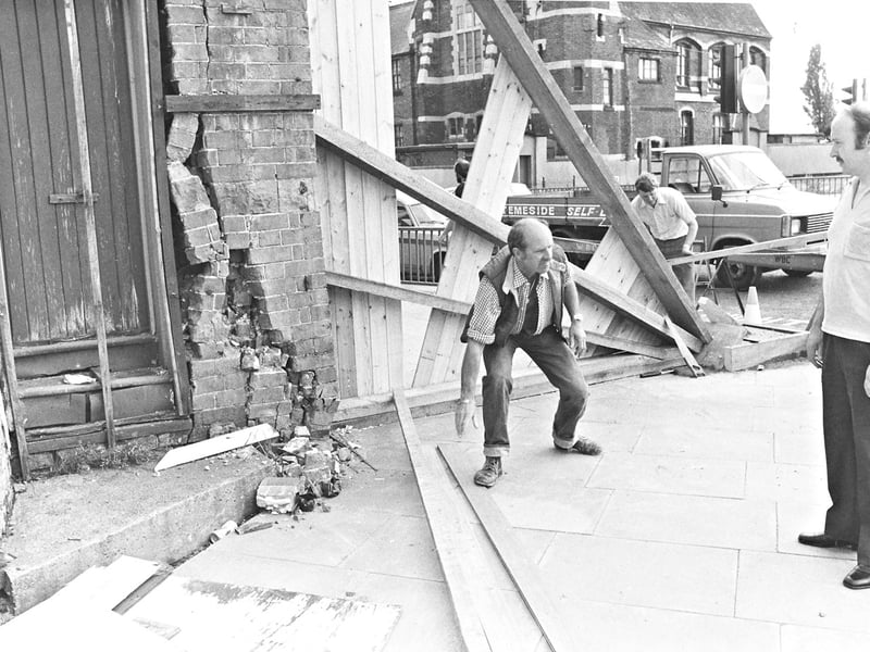 Workmen erect heavy timber shoring to shore up crumbling brickwork at the Hobbs carpet store on Snow Hill, Wolverhampton, in late June 1982. Emergency safety measures were launched to save one of the town's most historic buildings from structural collapse after a severe crack compromised the facade, prompting police to seal off the surrounding pavement to protect the public. Do you remember the drama on Snow Hill when emergency crews rushed to stabilise the historic landmark back in the summer of 1982?