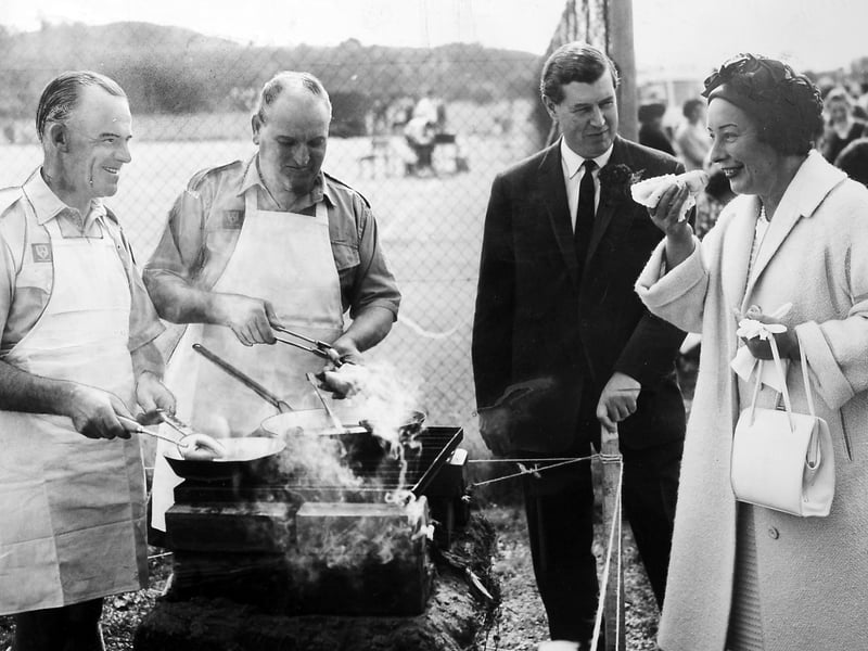 The school's Sports and Gala Day in September 1963. Sampling the cooking of the 2nd Dawley Scout Group is Mrs R Penrhyn-Owen, while her husband, who was general manager of Dawley New Town Development Corporation, looks on. The cooks are Scoutmasters D W Lloyd and W A Edwards.