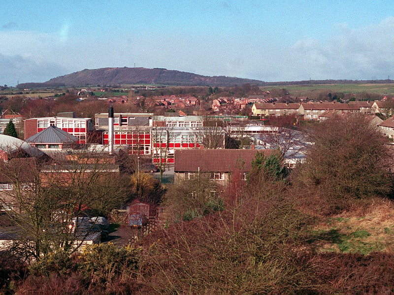A similar view in February 2002, showing some significant changes, including the growth of vegetation on the formerly barren pit mound. Today trees and shrubs would obscure the view. You'll notice the school has greatly expanded from its 1960s form.
