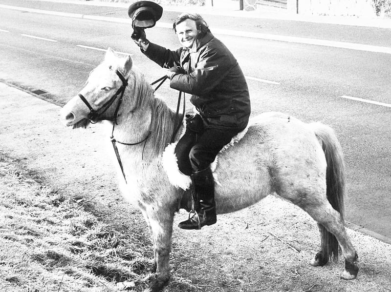 Ambulanceman Ted Bagnall tips his peaked cap from the saddle of his daughter Dawn's pony, Peppy, along the roadside in December 1982. Facing a cross-town transfer to the depot at New Cross after temporary drainage works closed his local station, the 46-year-old—who did not own a car—turned to four-legged horsepower for his new commute, hoping for permission to tether Peppy on the depot lawn. Do you remember spotting Ted and his novel ride en route to the ambulance station back in the winter of 1982?