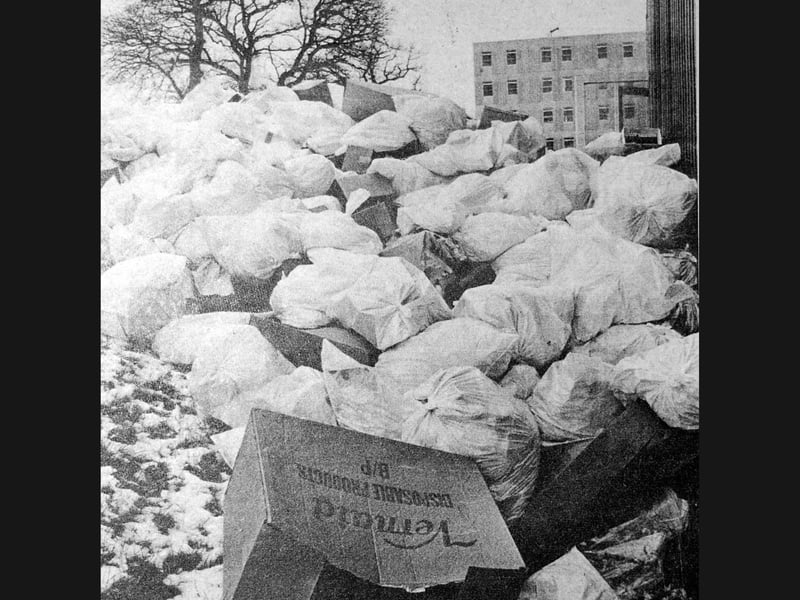 Piles of refuse sacks and discarded cardboard cartons dwarf the hospital grounds in February 1979 as industrial action by ancillary staff brings national winter of discontent disruption directly to the doors of the Royal Shrewsbury Hospital.  Do you remember visiting or working at the hospital while the piles of bags were mounting up outside? How did the widespread strikes and icy weather that winter impact daily life for you and your family across Shrewsbury?