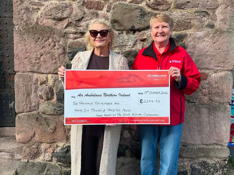 An Air Ambulance NI representative receiving a cheque from the Heart of the Glens Committee following the festival