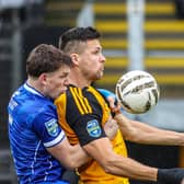 Limavady United’s Tiarnan Boorman and Carrick Rangers’ Adam Lecky compete for possession.