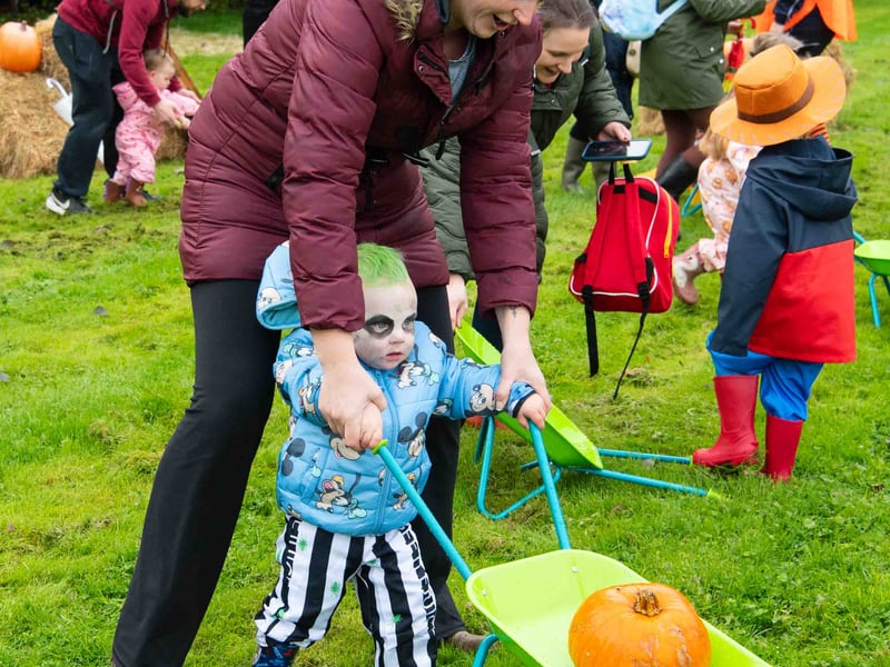 Getting a helping hand with a pumpkin.