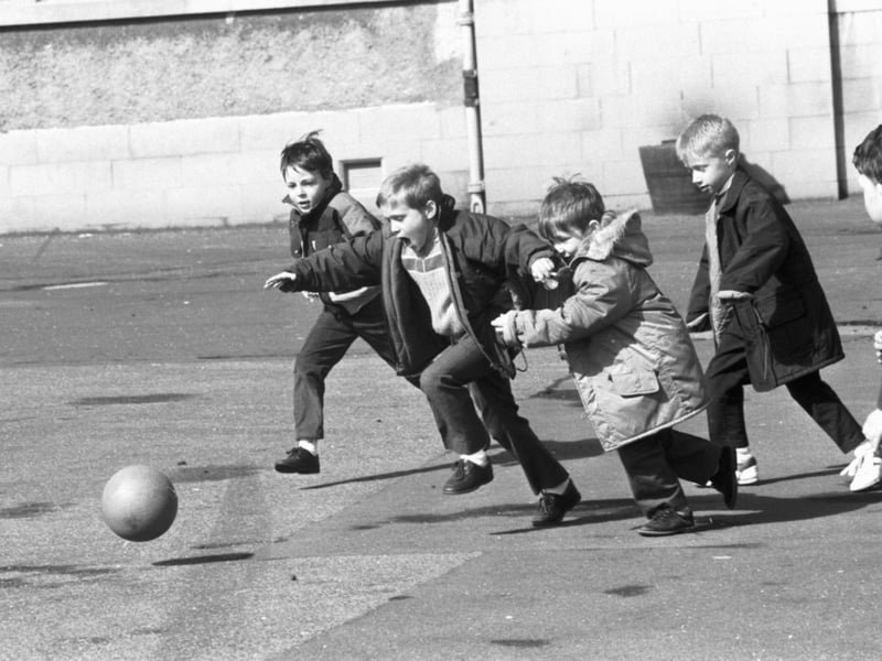Little boys playing football in the playground of St John's RC primary school in April 1989.