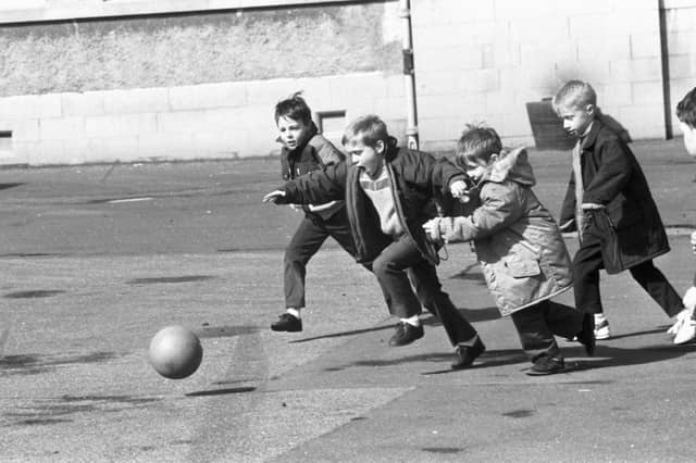 Little boys playing football in the playground of St John's RC primary school in April 1989.