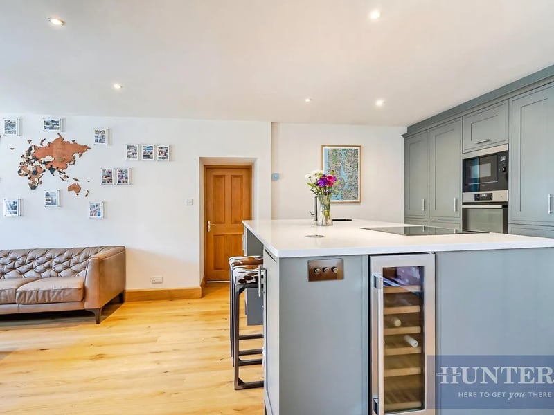The beautifully appointed kitchen, installed approximately six years ago, features integrated appliances including a fridge freezer and a dishwasher.
