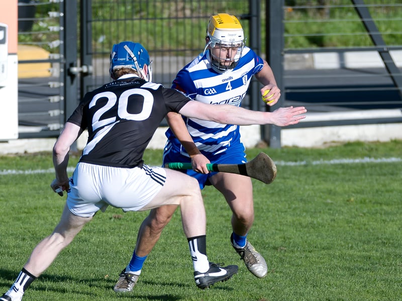 Naas corner back  Liam O'Reilly turns infield to avoid Conor O'Grady of Maynooth 