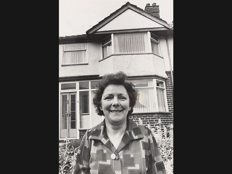 Blanche Thomas smiles outside her newly inherited property on Castle Road West, Oldbury, in June 1976. The 58-year-old Bearwood resident, who began her working life in domestic service as a parlourmaid before rising to cook and housekeeper, found herself the owner of three houses—having previously been bequeathed her Hagley Road home by former employer Frank Sanders, before recently inheriting £10,069 and the Oldbury house from friend Douglas Barkle. Do you remember hearing about Blanche's remarkable windfall and her pleasant dilemma over which home to settle in during the summer of 1976?