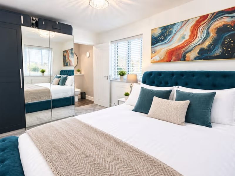 Bedroom one boasts a fitted wardrobe and an en-suite