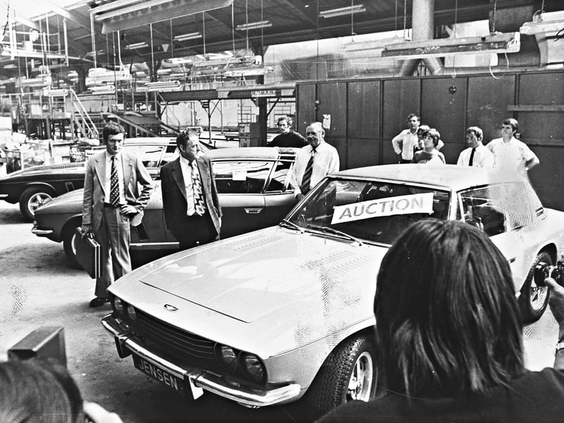 Businessman Eric Powell (centre) stands beside the last three Jensen Interceptors ever built at the company's West Bromwich works following a dramatic seven-minute auction in August 1976. Mr Powell secured the trio of prestigious British grand tourers for £33,000—including a unique "one-off" 7.2-litre Interceptor sold for £12,500—while remaining tight-lipped about the future of the coveted sports cars as production at the historic factory drew to a close. Do you remember the sleek lines of the Interceptors turning heads around West Bromwich or working at the Jensen plant before the gates shut in 1976?