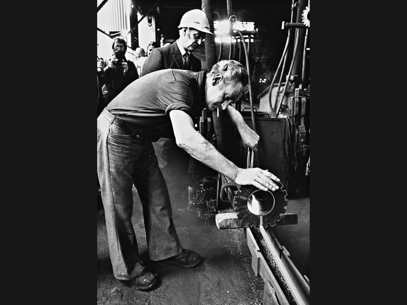 With a cigarette casually perched on his lip, Joe Washington measures the very last section of steel to be rolled at Birchley Rolling Mills in Oldbury, closely watched by mill manager George Murphy in May 1976. The poignant moment brought an end to over half a century of steel production at the First World War-era plant, which had survived political swings of nationalisation and privatisation before British Steel Corporation finally ran down operations, offering the remaining 80 men alternative jobs and retraining. Did you or a family member work on the hot rolling lines at Birchley before the furnaces went cold in the spring of 1976?