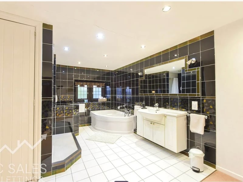 Relax in the corner bath or enjoy a freshen up in the shower in this luxurious family bathroom.