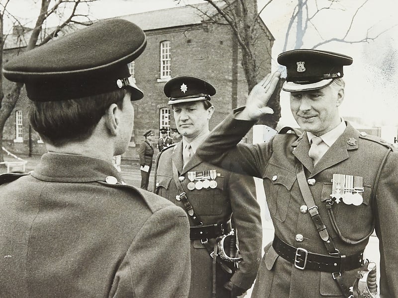 Lieutenant-Colonel Julian Goodbody (right) returns a smart salute on the dais alongside incoming commanding officer Lieutenant-Colonel John Bryant during a passing-out parade at Whittington Barracks, Lichfield, in March 1976. Marking the completion of training for Salerno platoon at the Prince of Wales’s Division Depot, the ceremony saw local recruits honoured for their discipline and fitness—with Private David White of Lones Road, West Bromwich, receiving the drill certificate and Private David Hill of Poole Road, Smethwick, awarded the physical training certificate. Did you complete your basic training at Whittington Barracks or attend a passing-out parade in Lichfield during 1976?