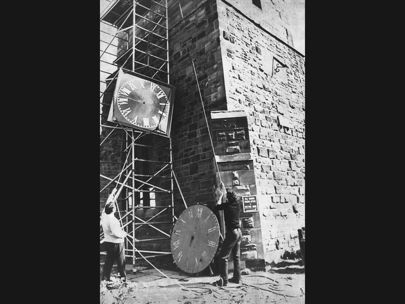Workmen Jeff Fletcher and Glen Attenborough, from specialist Derby clockmakers John Smith, winch a new glass-fibre clock dial into place 50 feet up the tower of All Saints' Church in West Bromwich circa 1976. The modern £1,500 timepiece, measuring five feet across, replaced a century-old cast-iron mechanism that had been dismantled the previous week, restoring a much-loved local landmark for passers-by glancing up to check the time. Did you rely on the All Saints' Church clock to keep you on schedule while walking through West Bromwich in the 1970s?