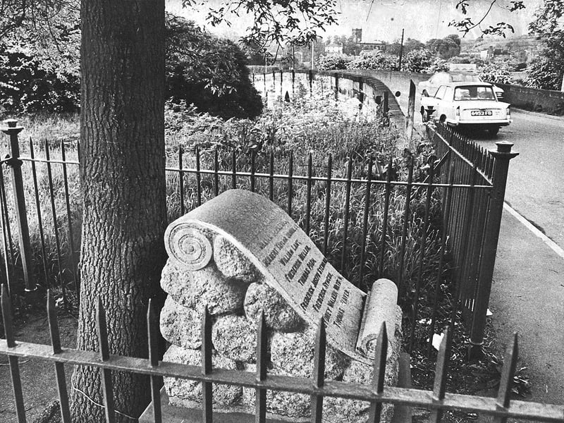 Enclosed by iron railings beside the roadway, a First World War stone memorial stands near the historic Walton River bridge in Stone, near Stafford, in June 1976. The six-foot monument became an unexpected obstacle to a £200,000 improvement scheme along the main A520 trunk road between the Walton roundabout and Stafford Street. Believed to have been erected by the former Walton Residents Association, the memorial needed to be relocated to allow road widening and a new bridge alongside the listed river crossing to proceed, leaving Staffordshire County Council searching for its legal owners to grant permission. Do you remember crossing the old Walton bridge or following the debates over road widening schemes around Stone in the summer of 1976?