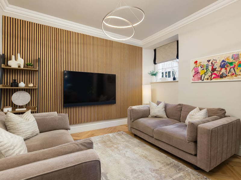 Upon entering, beautiful solid wood herringbone flooring leads through to the impressive dual-aspect open-plan living, dining and kitchen area. 