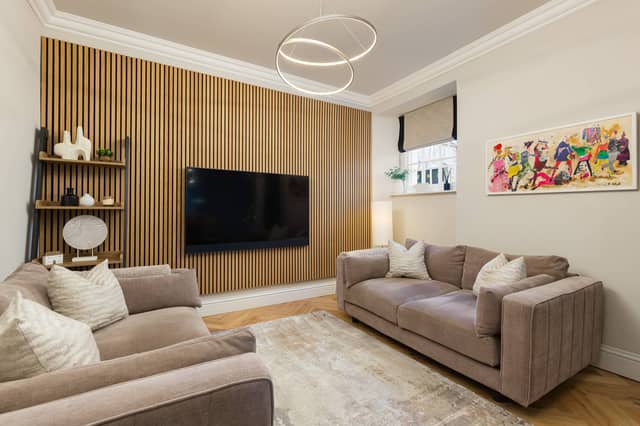 Upon entering, beautiful solid wood herringbone flooring leads through to the impressive dual-aspect open-plan living, dining and kitchen area.