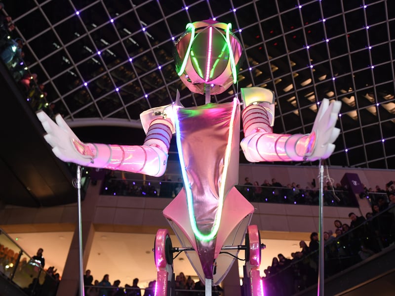Dancing robot queen IOLA 2.0 hosting her futuristic party to the centre. 
