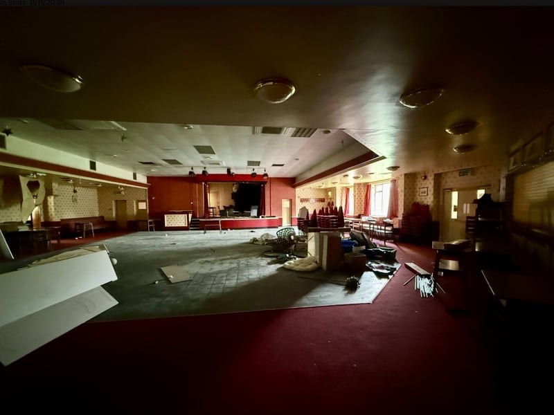 There is a large function room with a stage and dancefloor.