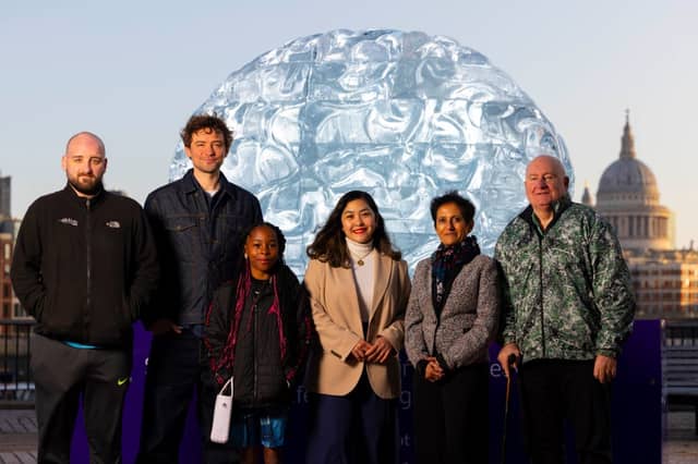 Jim, far right, with stroke survivors at the Stroke Association's ice brain sculpture in London. SU2645CD26