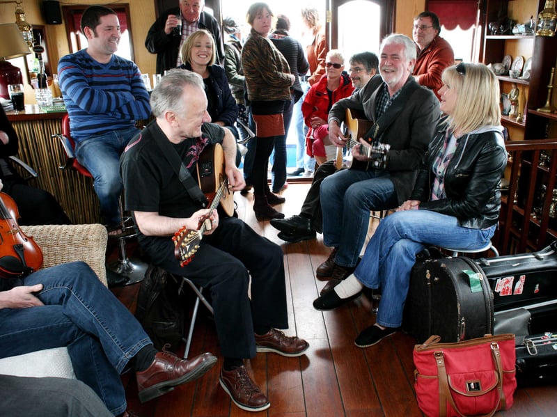 Donal Lunny on a barge in Carrick-on-Shannon with Charlie McGettigan and Eleanor Shanley in 2012.