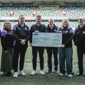 NI Football League Media and Communications Lead Gareth McCullough presents a cheque for £4989 to charity partners Players Against Dementia.