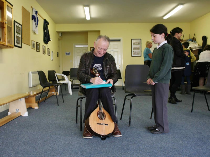 9 Years old Annie O'Hora from Carrick on Shannon Co Leitrim waits for an autograph from musician Donal Lunny in 2012.