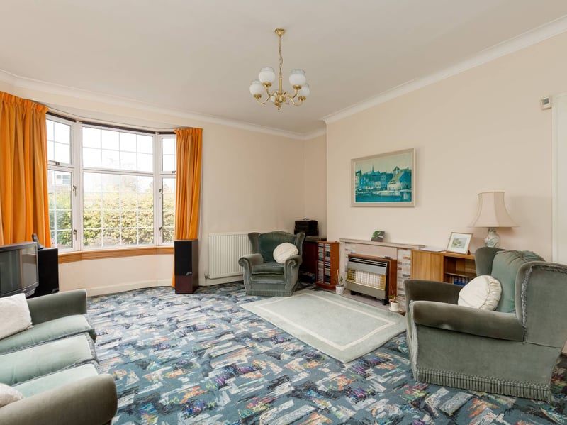 The sitting room features a bay window to the front and additional window to the side, allowing lots of natural light to fill the room.