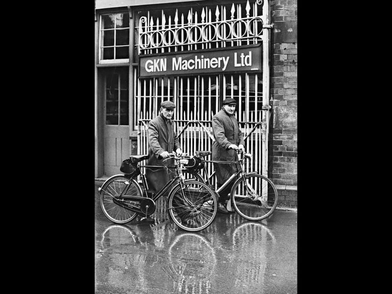 Two factory workers stand with their bicycles outside the iron gates of GKN Machinery Ltd in Wolverhampton, ready to pedal home through rain-slicked streets in June 1974. Unbeknown to the pair as their shift ended, their ultimate boss Sir Raymond Brookes had earlier that day praised GKN's 100,000-strong workforce as "a breed apart", declaring that anyone who worked for the company for five years was "superior" and "fine". The atmospheric scene captured the quiet dignity and daily routine of the thousands of industrial workers who kept the town's manufacturing heart beating. Did you cycle to work at GKN Machinery or recognise the familiar factory gates in Wolverhampton back in 1974?
