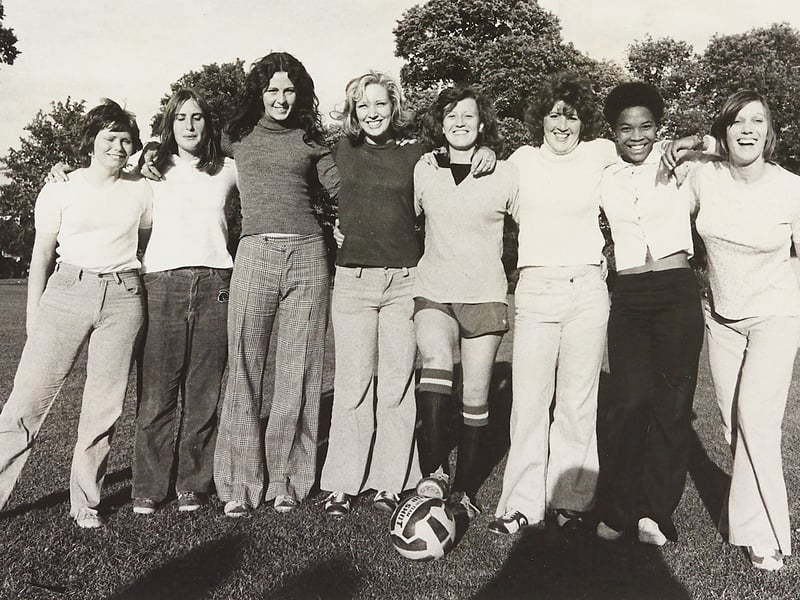Eight energetic workmates from Construction House, dubbed the "Tarmac Eves", line up arm-in-arm on the grass at Wolverhampton’s West Park for a training session in July 1974. Formed by staff from the local firm's headquarters, the squad took to the pitch against local men’s teams, with skipper Sue Baggott (pictured centre in full kit) putting out an appeal for female defenders and a goalkeeper to turn their pioneering side into a fully all-women lineup. Alongside Sue, team members Noreen Lloyd, Jackie Folks, Jane Hill, Irene Entwistle, Gillian Spilsbury, Pamela Quintyne, and Pat Flynn proved that Wolverhampton's workplace sporting spirit was thriving. Did you work at Tarmac's Construction House or remember watching the Tarmac Eves take to the field in West Park back in the summer of 1974?